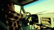 The truck driver plays some ear-splitting country music and is unaware of what is behind him