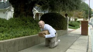 Larry in his final moments clutching his last stolen package.