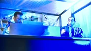 Somad and Siraki stunned after Somad inadvertently places the last tungsten carbide brick in place, resulting in a massive surge of radiation from the Demon Core in the lab, starting their extremely agonizing process