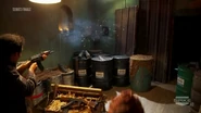 He loses control of it and it fires randomly in multiple directions, with some bullets making holes in one of the "hummus barrels"
