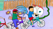 Children riding bikes past Human Eye