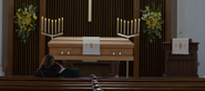 Jessica and Clay looking at Justin’s casket