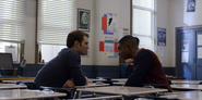 Bryce and Marcus talking in a classroom