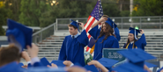 Clay and Jessica throwing their graduation caps