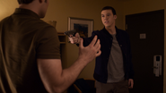 Tyler pointing a gun at Bryce