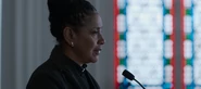 A pastor speaking at a funeral
