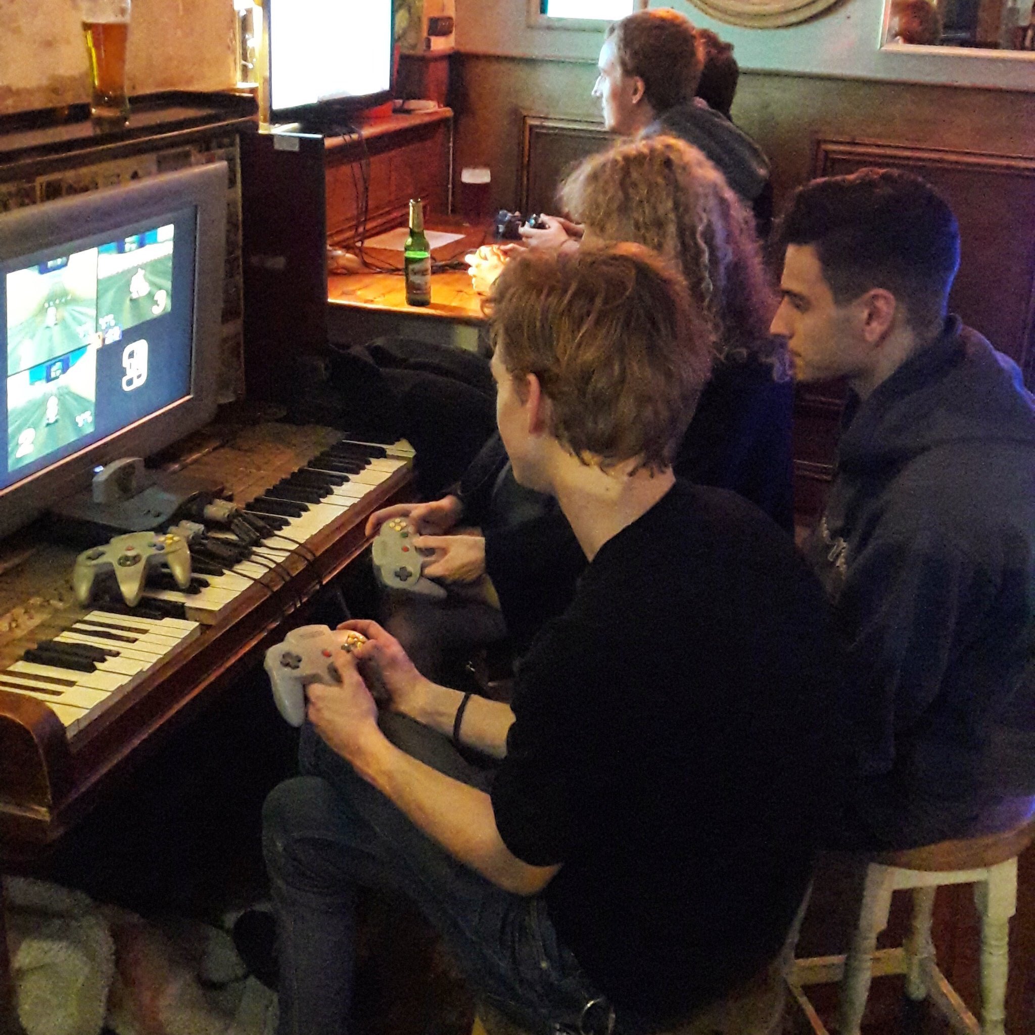 Thomas Brodie Sangster playing a video game in a pub yesterday