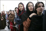 Women of Afghanistan stand outside the U.S. Embassy in Kabul, Wednesday, March 1, 2006. President George W. Bush and Laura Bush made a surprise visit to the city and presided over a ceremonial ribbon-cutting at the embassy.