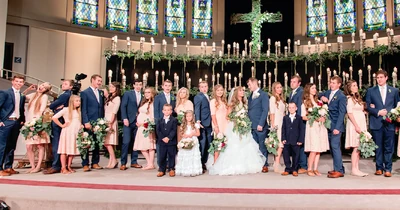 The wedding party takes a silly photo.