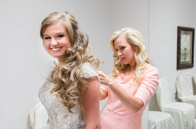 Kendra's mom helps her get ready.