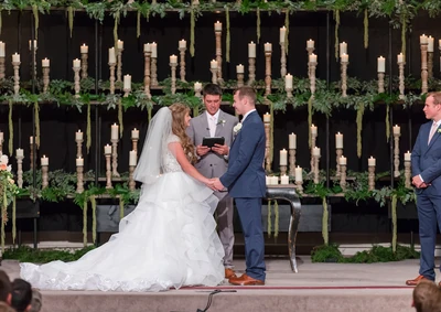 Kendra's father officiates the wedding.