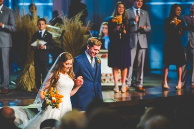 Austin and Joy walking back up the aisle.