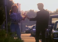 Tom giving Linda flowers.