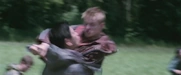 Cato digs a bar mace into the District 10 male's chest.