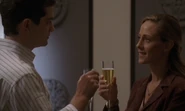 In 4x10, Audrey and Paul Raines share a glass of champagne.