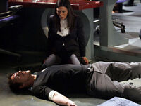 Nadia looks shocked at Milo's body