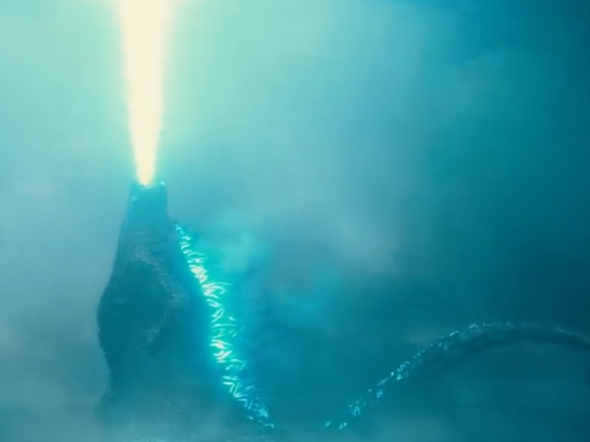 godzilla toy with blue fire