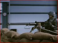 A soldier with a Browning M2HB guarding the entrance to District One.