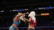 Charlotte Flair striking Alexa Bliss with a microphone in response to Bliss' disrespectful comments towards her father