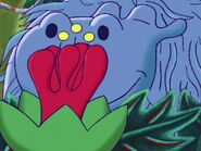 Henrietta smelling a flower.