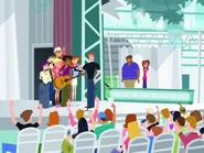 Star Contest: The Simon Cowell parody is next to Wyatt, while the other two judges are in the background at the judging table.