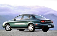 A green 1996 Ford Taurus sedan