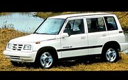 A white 1996 Geo Tracker (4-door)