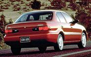 Back view of a red 1996 Geo Prizm sedan