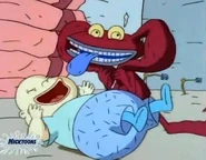 Ickis making faces at a human baby