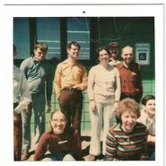 A group of us residents standing and sitting in front of Speare Cottage at Laconia State School