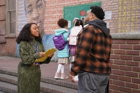 Janine tries to convince a parent to sign the petition.