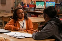 Janine and Nina's mother talking about Nina's struggles in class.