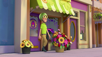 114a - Delivery man comes out of the flower shop