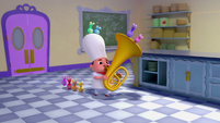 110a - Chef Jeff playing tuba in the kitchen