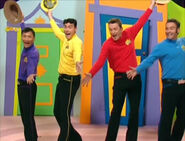 The Wiggles holding hats