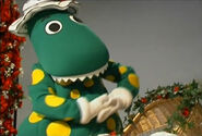 Dorothy the Dinosaur is dancing while rocking the baby to sleep