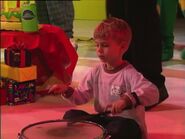 Timothy playing the drum drum