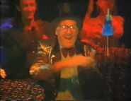 An old man with glasses in the audience clapping