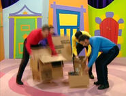 The Wiggles putting the boxes of hats down