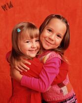 Ruby hugging little sister Gracie in Season 1.