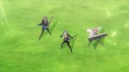 Saku, Sosuke, and Uta performing on the grass in the intro