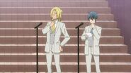 Ryo and Satsuma dressed up in uniforms by the microphones