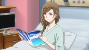 Nozomi reading a magazine in the hospital