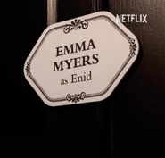 Emma Myers's name on a door announcing her role as Enid