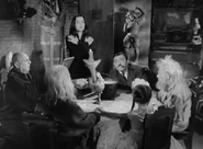 Seance.png (150 KB) Morticia, along with Gomez, Cousin Cackle, Wednesday, Grandmama and Uncle Fester holding a séance to contact Aunt Singe, to reassure Wednesday of the existence of witches.