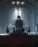 Wednesday Addams standing in a room
