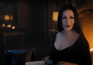Morticia holding the 1991 yearbook where Kathryn's name can be seen