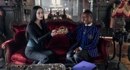 Morticia Addams and Bianca Barclay sitting