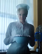Larissa appearing to Wednesday as a nurse