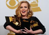 Musician-adele-poses-with-her-six-trophi-1